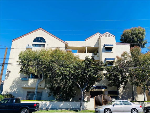 Front view of a multi-story building with triangular roof elements