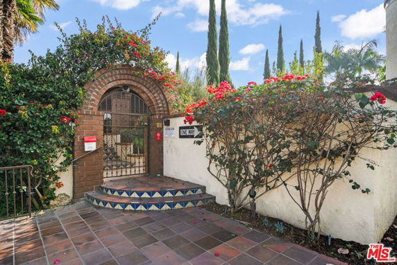 Entrance view of a house with a brick arch and decorative steps.