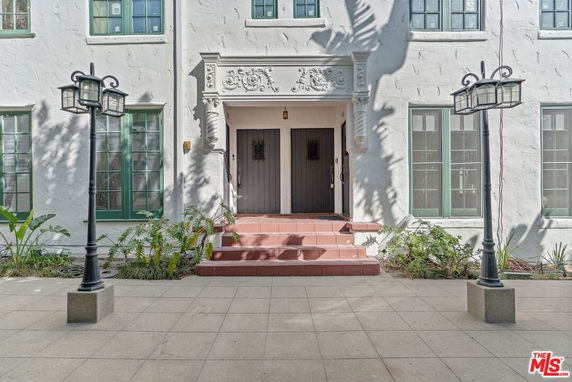 Front view of a building with decorative entrance and multiple windows.