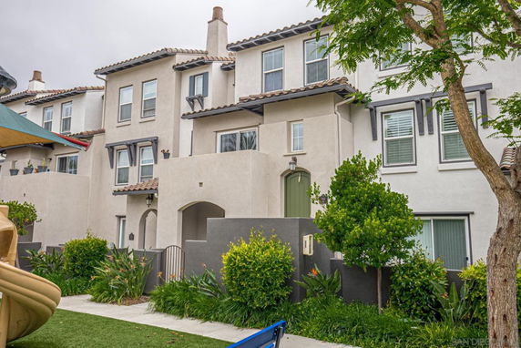 Front view of a multi-story house with white exterior and decorative elements.