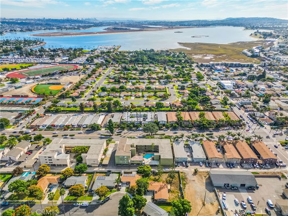 Panoramic view of residential area with surrounding areas, including water bodies and sports fields.