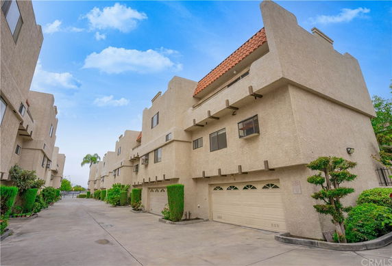 Front view of a multi-story building with garages.