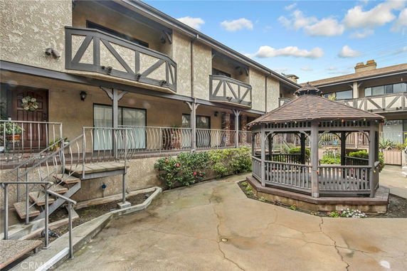 Front view of a two-story building with an outdoor gazebo.