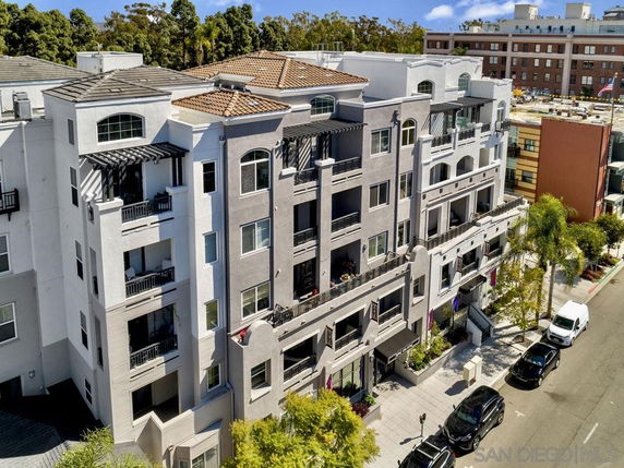 Front view of a multi-story apartment building with multiple balconies.