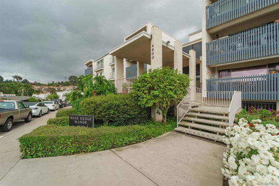 Front view of a multi-story building with stair access and balconies.