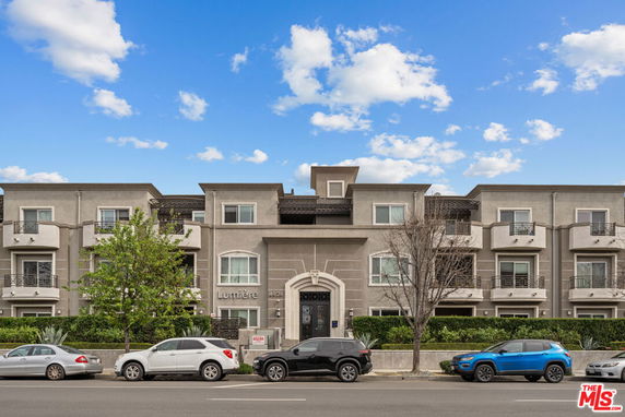 Front view of a multi-story residential building with balconies.
