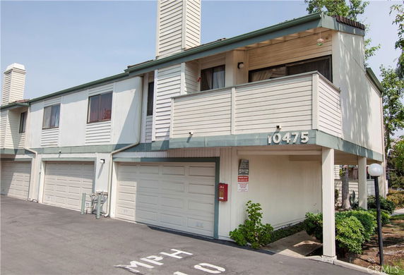 Front view of a two-story residential building with attached garages.