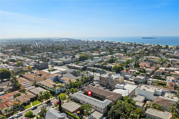 Panoramic view of a coastal city with residential and commercial buildings.
