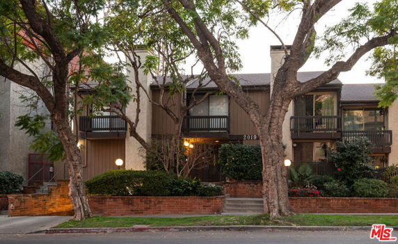 Front view of a multi-story residential building with balconies.