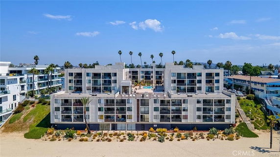 Front view of a multi-story beachfront apartment complex.