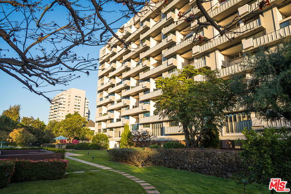 Front view of a multi-story residential building with balconies.