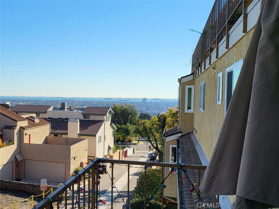 Panoramic view from a building overlooking the city and distant ocean.