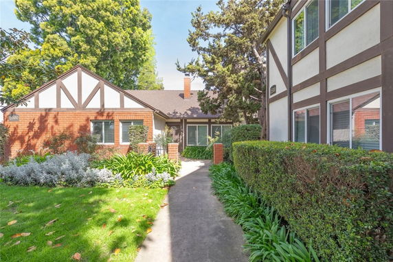 Front view of a house with Tudor-style elements and a brick facade.