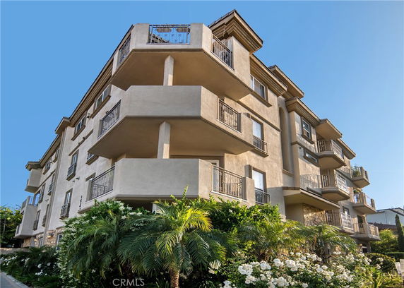 Front view of a multi-story apartment building with balconies.