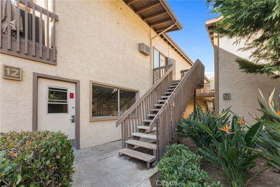 Front view of a two-story building with a staircase leading to the upper level.
