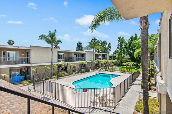 Outdoor swimming pool surrounded by apartment buildings.
