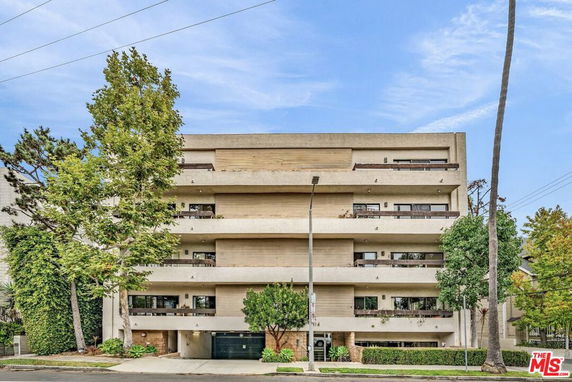Front view of a multi-story building with balconies.