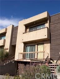 Front view of a multi-story building with a balcony.