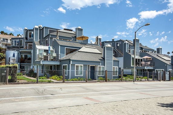 Front view of a multi-story residential building with multiple balconies.
