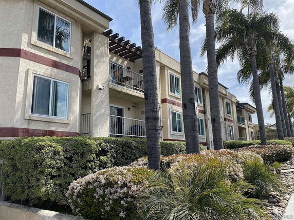 Front view of a multi-story residential building with balconies.