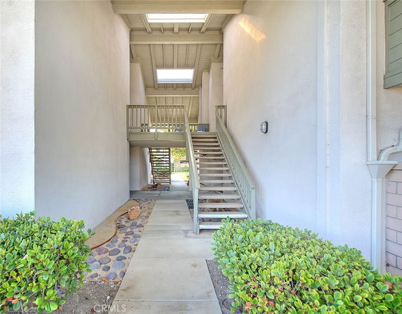 Front view of an open walkway with stairs leading to a second level.