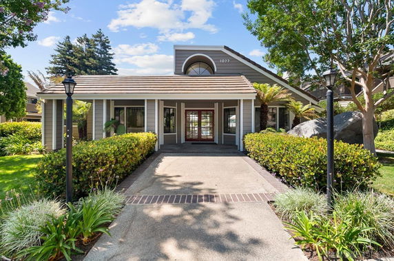 Front view of a house with a central entrance and pitched roof.