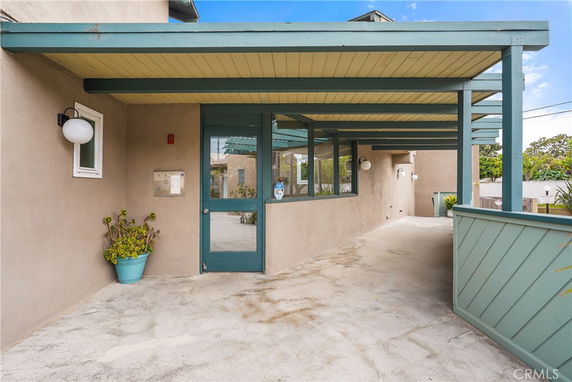 Front view of a building entrance with a covered porch and blue accents.