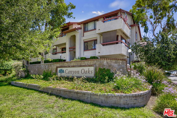 Front view of a multi-story residential building with balconies.