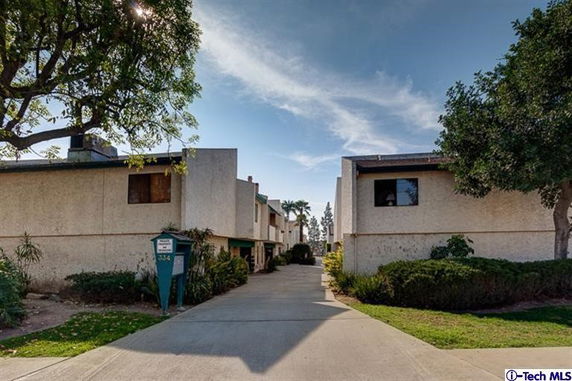 Front view of several two-story residential buildings with a central driveway.