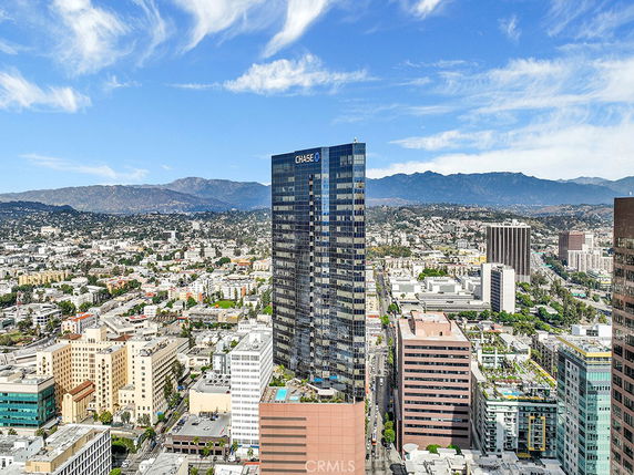 Panoramic view of a cityscape featuring a prominent high-rise building.