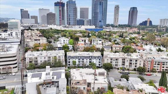 Panoramic view of a cityscape with skyscrapers and residential buildings.