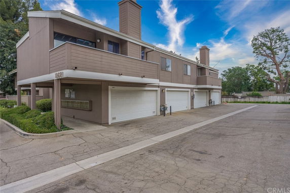 Front view of a multi-story residential building with garages.