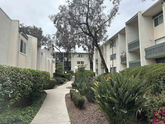 View of apartment buildings with garden pathways.