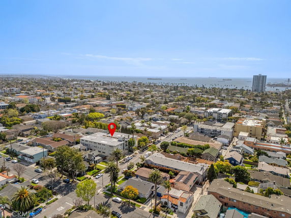 Aerial view of a densely populated urban area with houses and buildings near the ocean.