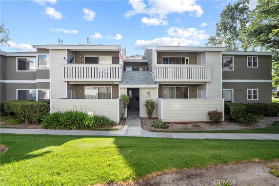 Front view of a two-story residential building with balconies.