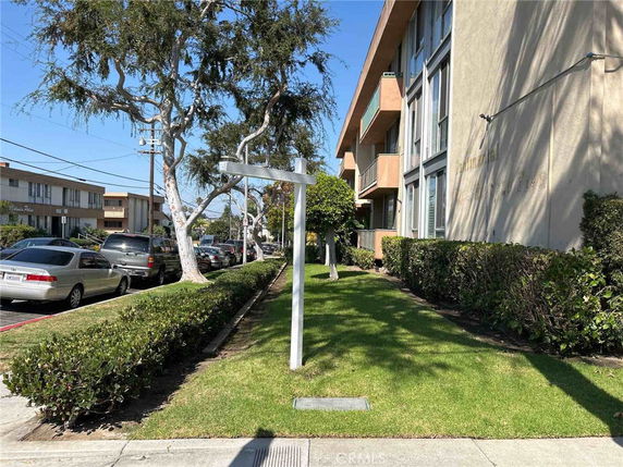Front view of a multi-story residential building with balconies.