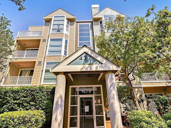 Front view of a multi-story residential building with a prominent entrance.