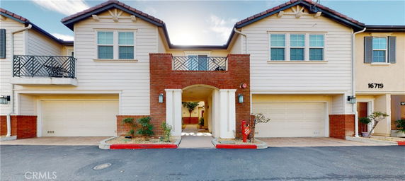Front view of a two-story house with two garages and a central entrance.