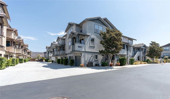 Front view of a multi-story residential building with garages.