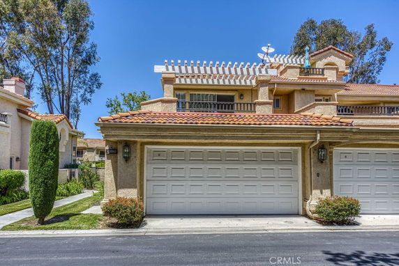 Front view of a house with a double garage and a tiled roof.