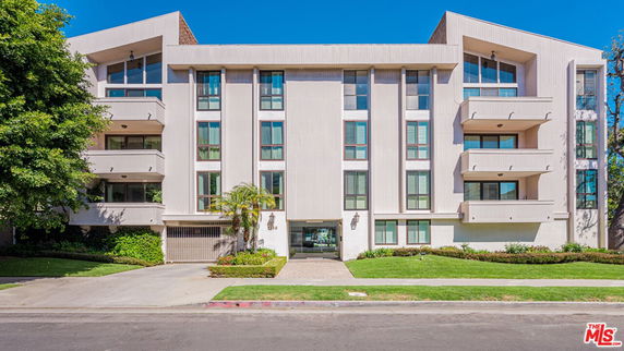 Front view of a modern multi-story building with balconies.