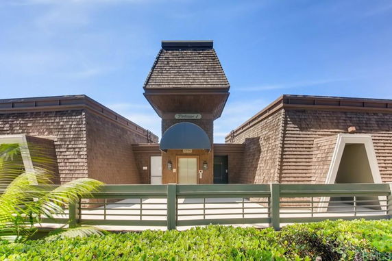 Front view of a building with a unique wooden architecture and central entrance.