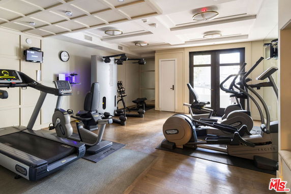 Indoor gym area with exercise equipment including treadmills and ellipticals.