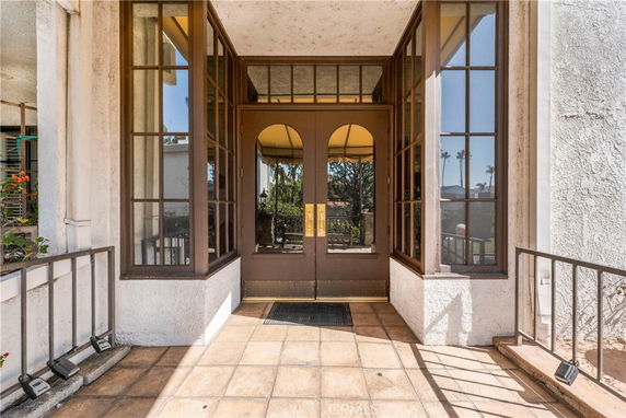 View of a building entrance with large glass windows and doors.
