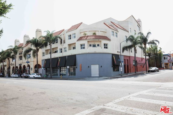 Front view of a three-story building with a Mediterranean-style architecture.