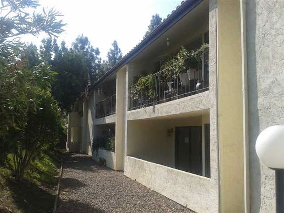 Side view of a multi-story building with balconies.