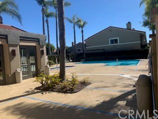 Outdoor swimming pool area with surrounding buildings.