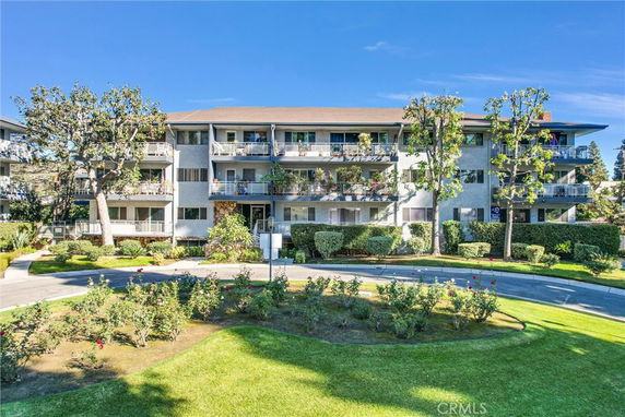 Front view of a multi-story residential building with balconies.