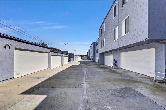 Outdoor parking area with several garages in a residential complex.