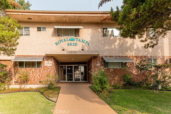 Front view of a residential building with a covered entryway.